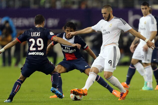 Paris Saint-Germain's Brazilian midfielder Lucas Moura (L) and Defender Marquinhos (C-Back) defend against Real Madrid's French striker Karim Benzema (R) during their friendly football match at the Aspire Academy of Sports Excellence in the Qatari capital Doha on January 2, 2014. Real Madrid won 1-0. AFP PHOTO/AL-WATAN DOHA/KARIM JAAFAR == QATAR OUT == (Photo credit should read KARIM JAAFAR/AFP/Getty Images) Paris Saint-Germain's Brazilian midfielder Lucas Moura (L) and Defender Marquinhos (C-Back) defend against Real Madrid's French striker Karim Benzema (R) during their friendly football match at the Aspire Academy of Sports Excellence in the Qatari capital Doha on January 2, 2014. Real Madrid won 1-0. AFP PHOTO/AL-WATAN DOHA/KARIM JAAFAR == QATAR OUT == (Photo credit should read KARIM JAAFAR/AFP/Getty Images)