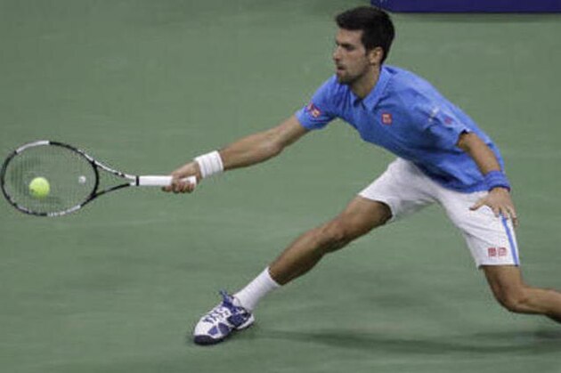 Novak Djokovic, of Serbia, returns a shot to Jerzy Janowicz, of Poland, during the first round of the US Open tennis tournament, Monday, Aug. 29, 2016, in New York. (AP Photo/Julio Cortez)