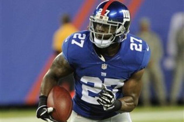 New York Giants safety Stevie Brown (27) runs back an interception during the first half of a preseason NFL football game against the New York Jets Saturday, Aug. 24, 2013, in East Rutherford N.J. (AP Photo/Bill Kostroun)