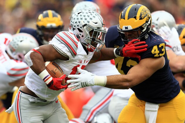 ANN ARBOR, MI - NOVEMBER 28: Running back Ezekiel Elliott #15 of the Ohio State Buckeyes runs the ball against the Michigan Wolverines at Michigan Stadium on November 28, 2015 in Ann Arbor, Michigan. Ohio State defeated Michigan 42-13. (Photo by Andrew Weber/Getty Images) ANN ARBOR, MI - NOVEMBER 28: Running back Ezekiel Elliott #15 of the Ohio State Buckeyes runs the ball against the Michigan Wolverines at Michigan Stadium on November 28, 2015 in Ann Arbor, Michigan. Ohio State defeated Michigan 42-13. (Photo by Andrew Weber/Getty Images)