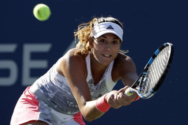 Garbine Muguruza, of Spain, returns a shot to Elise Mertens, of Belgium during the first round of the U.S. Open tennis tournament, Monday, Aug. 29, 2016, in New York. (AP Photo/Seth Wenig)