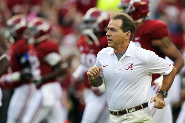 FILE - In this Oct. 19, 2013, file photo, Alabama head coach Nick Saban runs onto the field before the first half of an NCAA college football game against Arkansas in Tuscaloosa, Ala. Saban is one national title away from matching Bear Bryant's record and, with his 65th birthday coming up on Halloween, shows no signs of slowing down.  (AP Photo/Butch Dill, File)