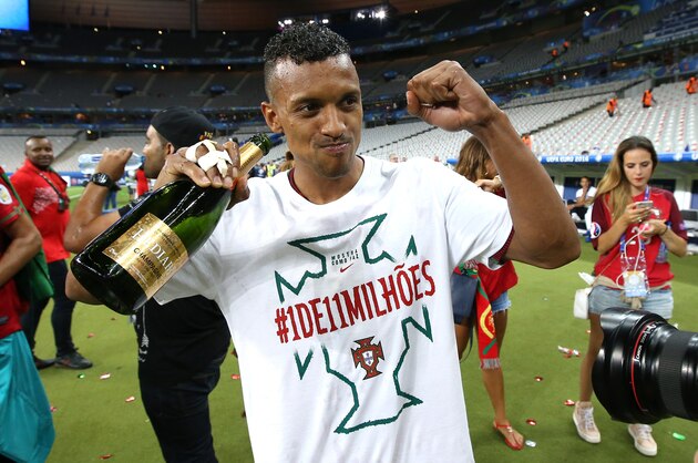 PARIS, FRANCE - JULY 10: Luis Nani of Portugal celebrates with champagne the victory following the UEFA Euro 2016 final match between Portugal and France at Stade de France on July 10, 2016 in Saint-Denis near Paris, France. (Photo by Jean Catuffe/Getty Images)