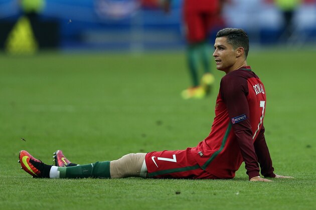 PARIS, FRANCE - JULY 10: Cristiano Ronaldo of Portugal lies injured during the UEFA Euro 2016 Final match between Portugal and France at Stade de France on July 10, 2016 in Paris, France. (Photo by Chris Brunskill Ltd/Getty Images)
