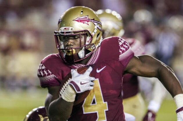 FILE - In this Sept. 5, 2015, file photo, Florida State running back Dalvin Cook runs the ball during the first half of an NCAA college football game against Texas State in Tallahassee, Fla. Florida State offense which returns all 11 starters , is led by Heisman Trophy contender Dalvin Cook. The junior rushed for a school-record 1,691 yards last season and tied for the national lead with six carries of 50 yards or more. (AP Photo/Mark Wallheiser, File)