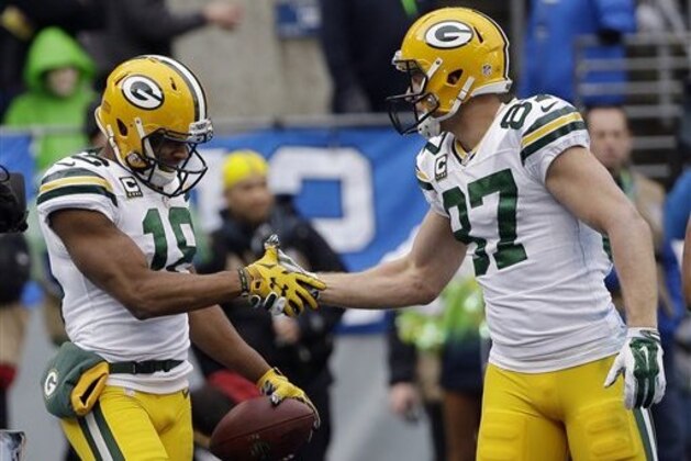 Green Bay Packers' Randall Cobb (18) celebrates his touchdown catch with Jordy Nelson (87) during the first half of the NFL football NFC Championship game against the Seattle Seahawks Sunday, Jan. 18, 2015, in Seattle. (AP Photo/David J. Phillip)