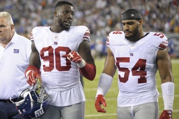 New York Giants defensive end Jason Pierre-Paul (90) talks to teammate Olivier Vernon (54) as he leaves the field after the first half of an NFL preseason football game against the New York Jets Saturday, Aug. 27, 2016, in East Rutherford, N.J.  (AP Photo/Bill Kostroun)