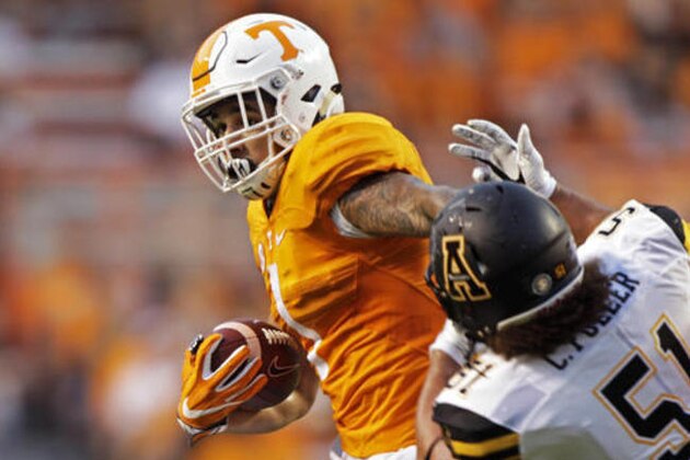 Tennessee running back Jalen Hurd (1) escapes from Appalachian State defensive lineman Caleb Fuller (51) during the first half of an NCAA college football game Thursday, Sept. 1, 2016 in Knoxville, Tenn. (AP Photo/Wade Payne)