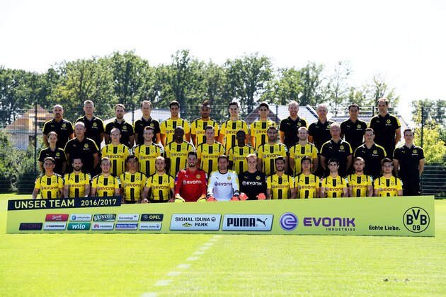 Back row (L-R) Thomas Zetzmann, Peter Kuhnt, Thorben Voeste, Markus Braun, Mikel Merino, Pierre-Emerick Aubameyang, Julian Weigl, Marc Bartra, Benjamin Weber, Teddy de Beer, Arno Michels, Thomas Tuchel, second row (L-R) Swantje Thomssen, Frank Graefen, Sebastian Rode, Marco Reus, Adrian Ramos, Lukasz Piszczek, Ousmane Dembele´, Sokratis, Andre Schuerrle, Rainer Schrey, Andreas Beck, Florina Wrangler,front row (L-R) Emre Mor, Gonzalo Castro, Felix Passlack, Kagawa Shinji, Mario Goetze, Roman Buerki, Roman Weidenfeller, Hendrik Bonmann, Nuri Sahin, Joo Ho Park, Christian Pulisic, Marcel Schmelzer, Raphael Guerreiro poses for a team photo on August 17, 2016 in Dortmund, western Germany. / AFP / Patrik STOLLARZ        (Photo credit should read PATRIK STOLLARZ/AFP/Getty Images)