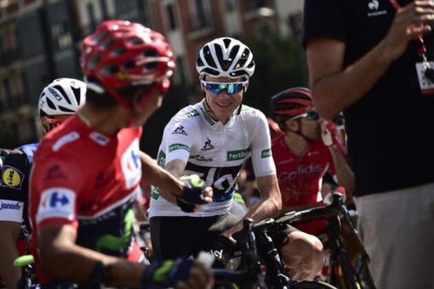 Sky's Team Christopher Froome of Britain, center, shakes hand with shirt race leader, Movistar's Team Nairo Quintana of Colombia, before the star the 13th stage between Bilbao and Urdax Dantxarinea, 213,4 kilometers (132,6 miles), of the Spanish Vuelta cycling race that finish in Bilbao, northern Spain, Friday, Sept. 2, 2016. (AP Photo/Alvaro Barrientos)