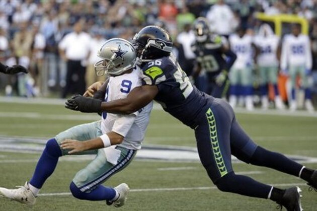 Dallas Cowboys quarterback Tony Romo, left, is tackled by Seattle Seahawks defensive end Cliff Avril, right, in the first half of a preseason NFL football game, Thursday, Aug. 25, 2016, in Seattle. (AP Photo/Elaine Thompson)