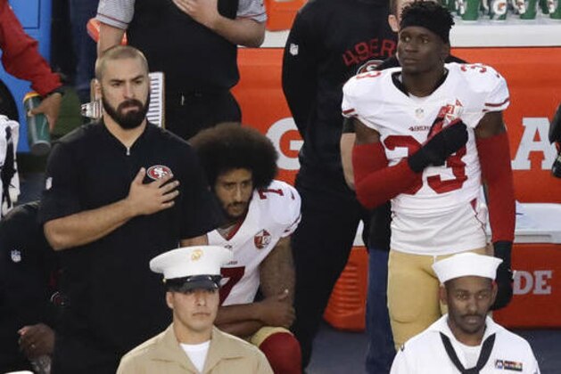 San Francisco 49ers quarterback Colin Kaepernick, middle, kneels during the national anthem before the team's NFL preseason football game against the San Diego Chargers, Thursday, Sept. 1, 2016, in San Diego. (AP Photo/Chris Carlson)