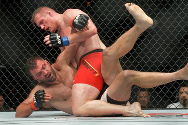 Andrei 'The Pit Bull' Arlovski from Belarus, below, and Josh 'The Warmaster' Barnett from the U.S compete at the UFC Fight Night in Hamburg, northern Germany, Saturday, Sept. 3, 2016. (AP Photo/Axel Heimken)