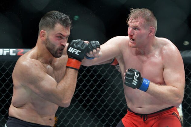 Andrei 'The Pit Bull' Arlovski from Belarus, left, and Josh 'The Warmaster' Barnett from the U.S compete at the UFC Fight Night in Hamburg, northern Germany, Saturday, Sept. 3, 2016. (AP Photo/Axel Heimken)