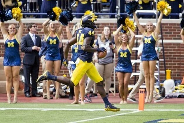 Michigan safety Delano Hill (44) returns an interception for a touchdown in the second quarter of an NCAA college football game against Hawaii at Michigan Stadium in Ann Arbor, Mich., Saturday, Sept. 3, 2016. (AP Photo/Tony Ding)