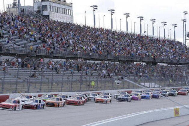 Paul Menard leads the pack at the start of the NASCAR Xfinity Series auto race at Darlington Raceway, Saturday, Sept. 3, 2016, in Darlington, S.C. (AP Photo/Terry Renna)