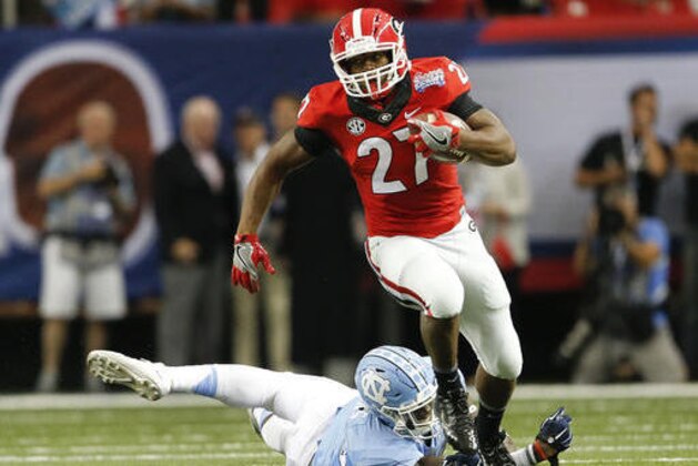 Georgia running back Nick Chubb (27) breaks away from North Carolina linebacker Cayson Collins (23) in the first half of an NCAA college football game in Atlanta, Saturday, Sept. 3, 2016. (AP Photo/John Bazemore)