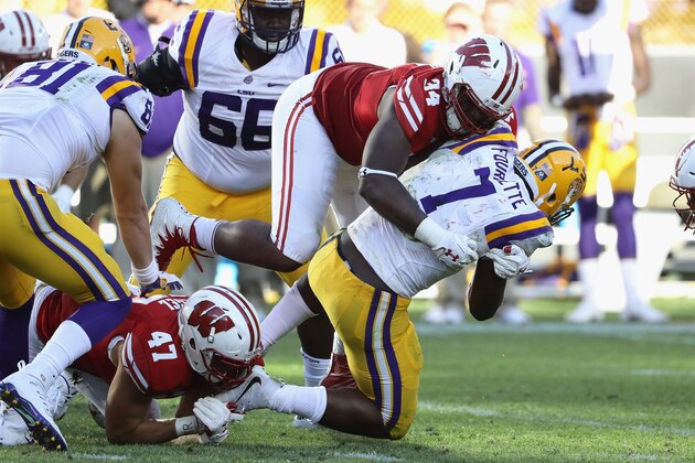 GREEN BAY, WI - SEPTEMBER 03:  Chikwe Obasih #34 of the Wisconsin Badgers tackles Leonard Fournette #7 of the LSU Tigers during the second half at Lambeau Field on September 3, 2016 in Green Bay, Wisconsin.  (Photo by Jonathan Daniel/Getty Images)