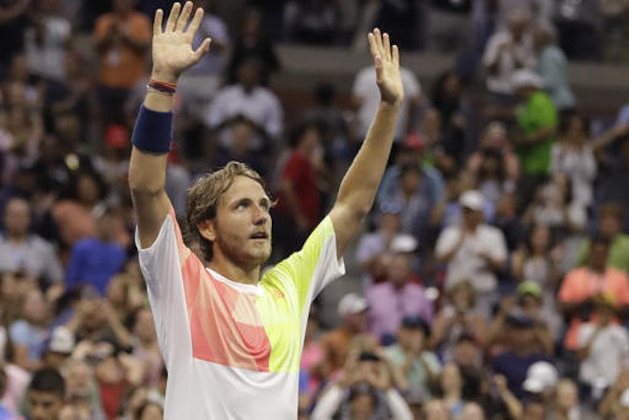 Lucas Pouille, of France, waves to fans after beating Rafael Nadal, of Spain, during the fourth round of the U.S. Open tennis tournament, Sunday, Sept. 4, 2016, in New York. (AP Photo/Darron Cummings)