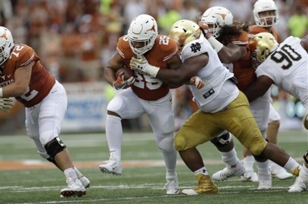 Texas running back Chris Warren III (25) tries to break a tackle during the first half of an NCAA college football game against Notre Dame, Sunday, Sept. 4, 2016, in Austin, Texas. (AP Photo/Eric Gay)