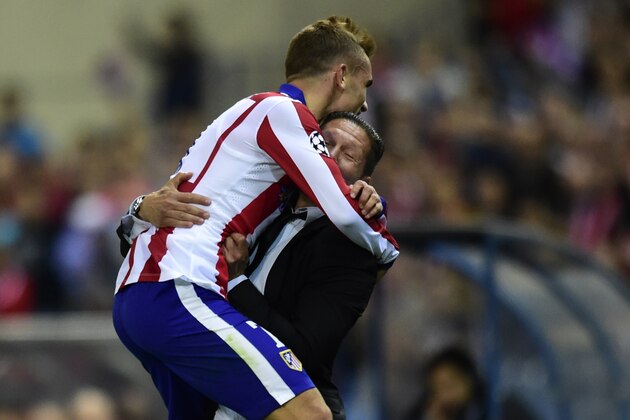 Atletico Madrid's French forward Antoine Griezmann (L) celebrates with Atletico Madrid's Argentinian coach Diego Simeone after scoring their third goal during the UEFA Champions League football match Club Atletico de Madrid vs Malmo FF at the Vicente Calderon stadium in Madrid on October 22, 2014.   AFP PHOTO/ JAVIER SORIANO        (Photo credit should read JAVIER SORIANO/AFP/Getty Images)