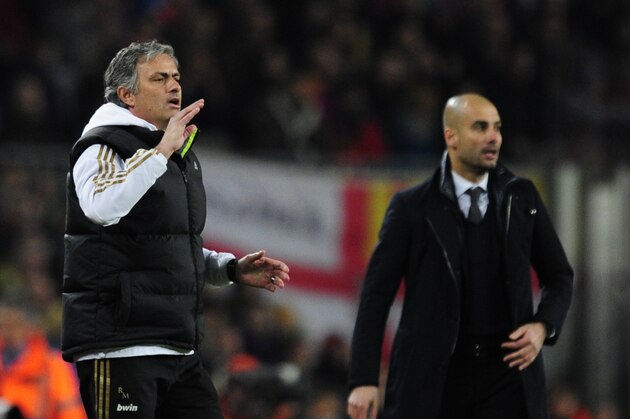 Real Madrid's Portuguese coach Jose Mourinho (L) gestures in front of Barcelona's coach Josep Guardiola (R) after Real Madrid's defender Sergio Ramos received a red card during the second leg of the Spanish Cup quarter-final 'El clasico' football match Barcelona vs Real Madrid at the Camp Nou stadium in Barcelona on January 25, 2012.  AFP PHOTO/JAVIER SORIANO (Photo credit should read JAVIER SORIANO/AFP/Getty Images)
