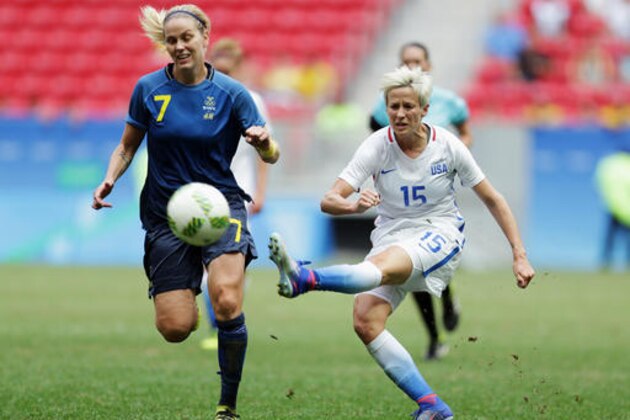 FILE - In this Friday, Aug. 12, 2016, file photo, United States' Megan Rapinoe, right, kicks the ball past Sweden's Lisa Dahlkvist during a quarterfinal match of the women's Olympic soccer tournament in Brasilia. Rapinoe knelt during the national anthem Sunday, Sept. 4, before the Seattle Reign's game against the Chicago Red Stars