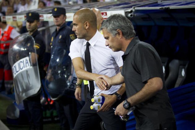 FILE- In this Sunday Aug. 14, 2011 file picture, the then Real Madrid's coach Jose Mourinho from Portugal, right, shakes hands with former Barcelona's coach Josep Guardiola before their Super Cup first leg soccer match at the Santiago Bernabeu stadium, in Madrid. Mourinho and Guardiola will go head-to-head for the first time as English Premier League managers on Sept. 10 when Manchester United and Manchester City meet in the derby at Old Trafford. (AP Photo/Daniel Ochoa de Olza, File)