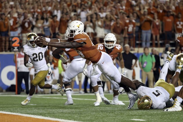 Sep 4, 2016; Austin, TX, USA;  Texas Longhorns quarterback Tyrone Swoopes (18) dives and scores the game winning touchdown past Notre Dame Fighting Irish linebacker Nyles Morgan (5) in overtime at Darrell K Royal-Texas Memorial Stadium. Mandatory Credit: Kevin Jairaj-USA TODAY Sports