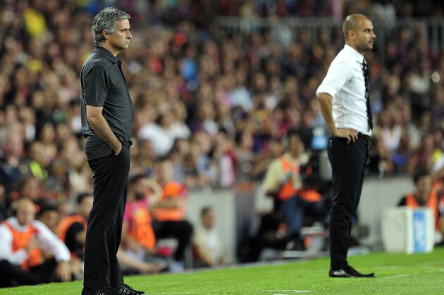 Real Madrid's Portuguese coach Jose Mourinho (L) and Barcelona's coach Josep Guardiola (R) look on during the second leg of the Spanish Supercup football match FC Barcelona vs Real Madrid CF on August 17, 2011 at the Camp Nou stadium in Barcelona.     AFP PHOTO/ JOSEP LAGO (Photo credit should read JOSEP LAGO/AFP/Getty Images)