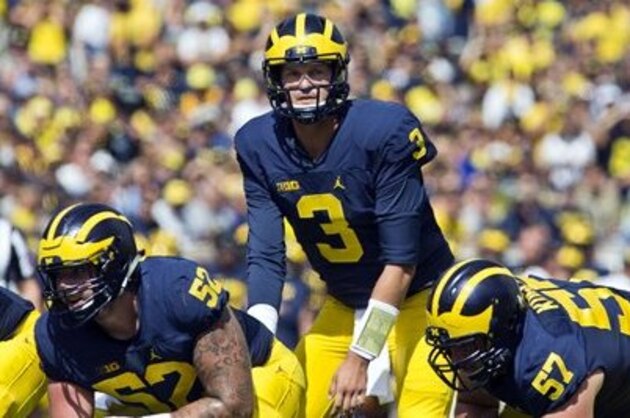 Michigan quarterback Wilton Speight (3) gets into position behind his offensive line between downs in the first quarter of an NCAA college football game against Hawaii at Michigan Stadium in Ann Arbor, Mich., Saturday, Sept. 3, 2016. Michigan won 63-3. (AP Photo/Tony Ding)