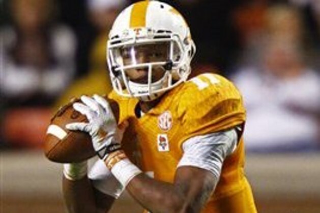 Tennessee quarterback Joshua Dobbs (11) looks for a receiver as he's pressured by Missouri defensive lineman Josh Augusta (97) in the second half of an NCAA college football game Saturday, Nov. 22, 2014 in Knoxville, Tenn. Missouri won 29-21. (AP Photo/Wade Payne)