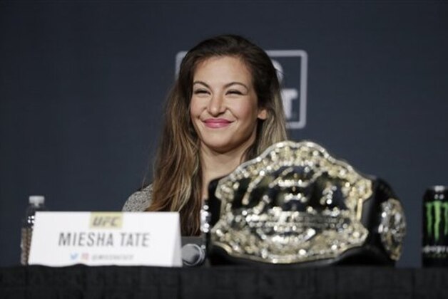Miesha Tate smiles during a UFC 200 mixed martial arts news conference, Wednesday, July 6, 2016, in Las Vegas. Tate is scheduled to fight Amanda Nunes in a women’s bantamweight championship fight at UFC 200 on Saturday. (AP Photo/John Locher)