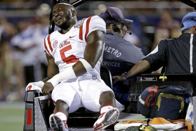 Mississippi defensive back Ken Webster grimaces as he leaves the field after he was injured during the first half of an NCAA college football game against Florida State, Monday, Sept. 5, 2016, in Orlando, Fla. (AP Photo/John Raoux)