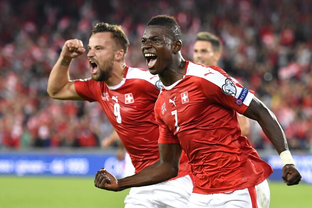 Switzerland's forward Breel Embolo (R) celebrates his team's first goal with teammate forward Haris Seferovic during the World Cup 2018 football qualifier between Switzerland and Portugal at the St. Jakob-Park stadium in Basel on September 6, 2016. / AFP / FABRICE COFFRINI        (Photo credit should read FABRICE COFFRINI/AFP/Getty Images)
