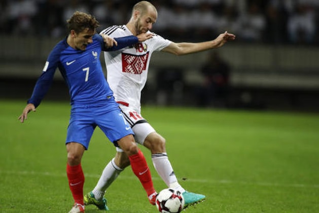 France's Antoine Griezmann, left, challenges for the ball with Belarus' Ivan Maevski during their World Cup Group A qualifying match between France and Belarus at the Borisov-Arena stadium in Borisov, Belarus, Tuesday, Sept. 6, 2016. (AP Photo/Sergei Grits)