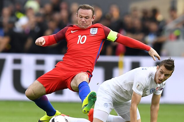 England's forward Wayne Rooney (L) vies with Slovakia's midfielder Jan Gregus during the World Cup 2018 football qualification match between Slovakia and England in Trnava, Slovakia, on September 4, 2015.  / AFP / JOE KLAMAR        (Photo credit should read JOE KLAMAR/AFP/Getty Images)