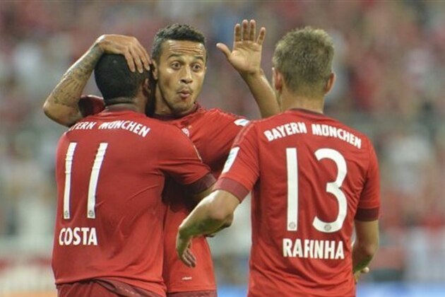 Bayern's Douglas Costa, Thiago and Rafinha, from left, celebrate after Costa scored their fifth goal during the German Bundesliga soccer match between FC Bayern Munich and Hamburger SV in Munich, southern Germany, Friday, Aug. 14, 2015. (AP Photo/Kerstin Joensson)