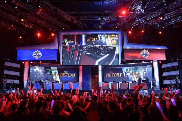 Visitors cheer for international teams during the tournament of the computer game 'League of Legends' on May 8, 2014 in Paris. Launched late in 2009 by American video game publisher Riot Games, 'League of Legends' is a game in which teams of five players compete in a virtual arena, killing each other using different powers and equipments in the goal to capture the enemy base. According to Riot Games, more than 67 million people play each month, with peaks of more than 7.5 million concurrent players at peak hours. The game will last four days starting today. AFP PHOTO / LIONEL BONAVENTURE        (Photo credit should read LIONEL BONAVENTURE/AFP/Getty Images)