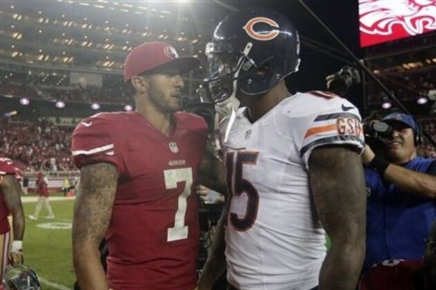 San Francisco 49ers quarterback Colin Kaepernick (7) talks with Chicago Bears wide receiver Brandon Marshall (15) after an NFL football game in Santa Clara, Calif., Sunday, Sept. 14, 2014. (AP Photo/Marcio Jose Sanchez)