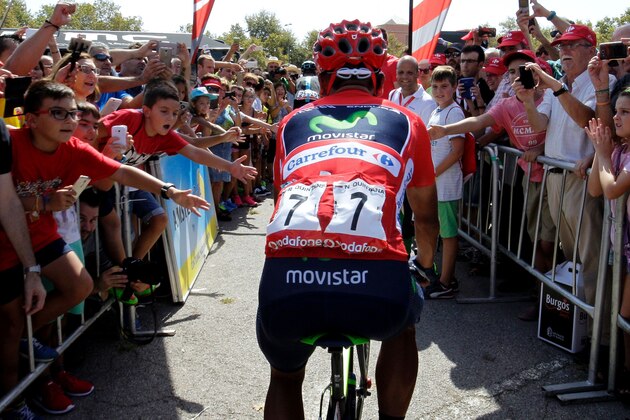 Movistar's Colombian cyclist Nairo Quintana (C) rides past supporters before the start of the 17th stage of the 71st edition of 'La Vuelta' Tour of Spain, a 173.3km route Castellon to Llucena, on September 7, 2016. / AFP / JOSE JORDAN        (Photo credit should read JOSE JORDAN/AFP/Getty Images)
