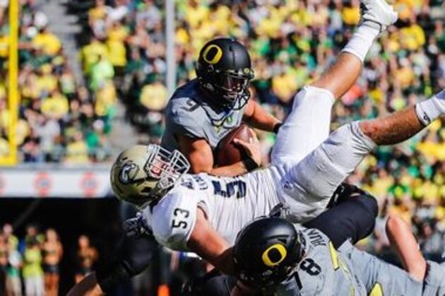 Oregon quarterback Dakota Prukop (9), avoids a collision as UC Davis linebacker Russell Reeder (53) and Oregon offensive lineman Cameron Hunt (78) tangle during an NCAA college football game in Eugene, Ore., Saturday, Sept. 3, 2016. Oregon won 53-28. (AP Photo/Thomas Boyd)