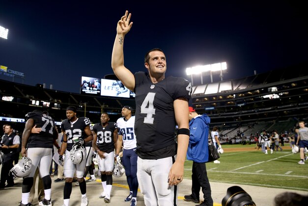 Aug 27, 2016; Oakland, CA, USA; Oakland Raiders quarterback Derek Carr (4) waves towards the crowd after the game at Oakland Alameda Coliseum. The Tennessee Titans defeated the Raiders 27-14. Mandatory Credit: Cary Edmondson-USA TODAY Sports