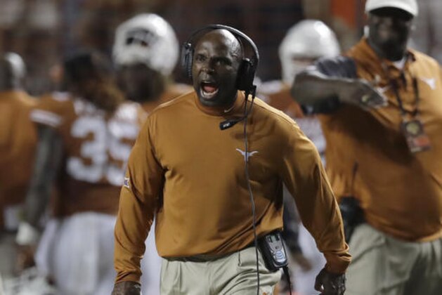 FILE - In this Sept. 4, 2016, file photo, Texas head coach Charlie Strong calls to his players during the second half of an NCAA college football game against Notre Dame, in Austin, Texas. One weekend has already changed the tone of the Big 12, and teams on opposite sides of the Red River separating Oklahoma and Texas. (AP Photo/Eric Gay, File)