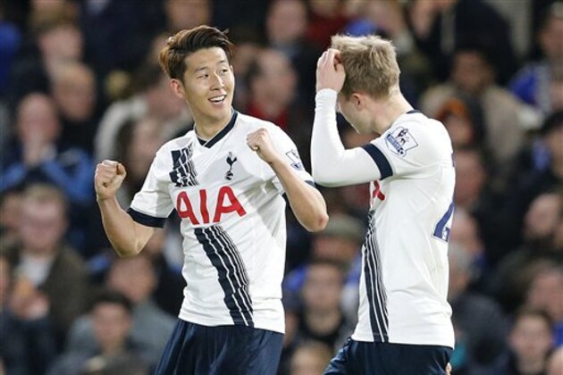 Tottenham's Son Heung-min, left, celebrates with Christian Eriksen after he scores a goal during the English Premier League soccer match between Chelsea and Tottenham Hotspur at Stamford Bridge stadium in London, Monday, May 2, 2016. (AP Photo/Frank Augstein)