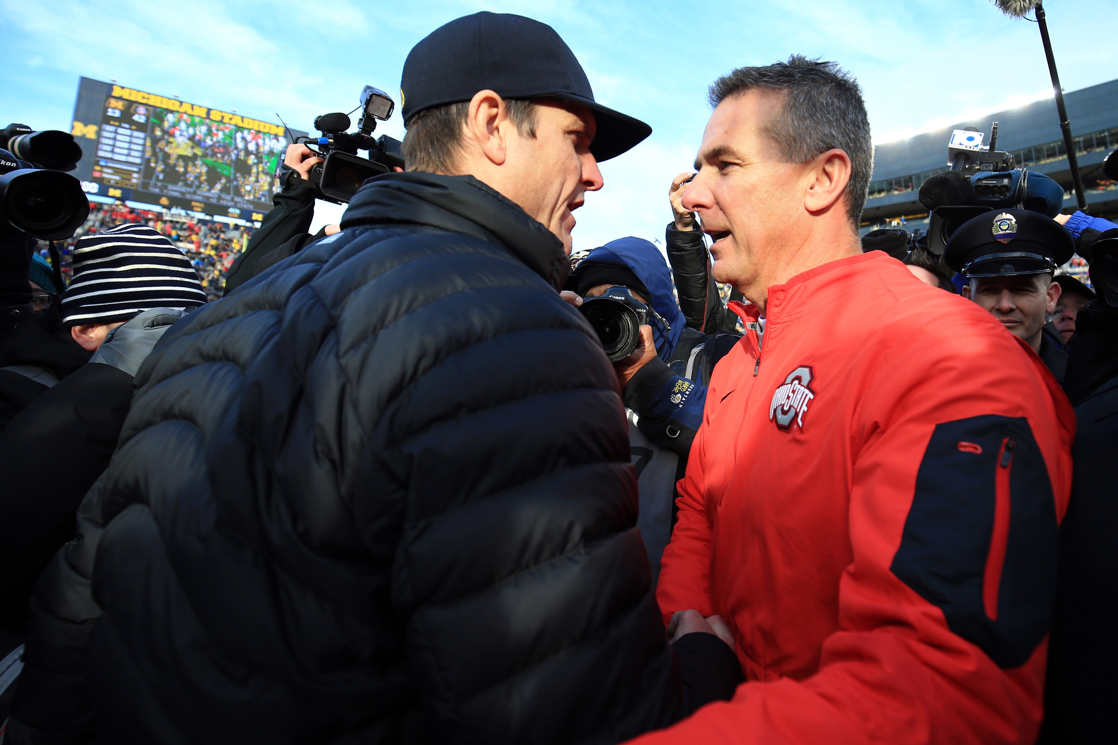ANN ARBOR, MI - NOVEMBER 28: Head coach Urban Meyer of the Ohio State Buckeyes and head coach Jim Harbaugh of the Michigan Wolverines after the game against the Michigan Wolverines at Michigan Stadium on November 28, 2015 in Ann Arbor, Michigan. Ohio State defeated Michigan 42-13. (Photo by Andrew Weber/Getty Images)