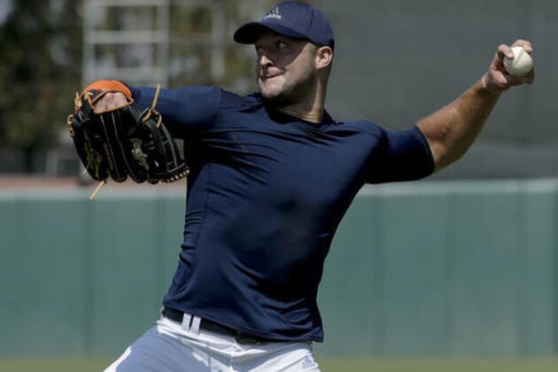 Former NFL quarterback, Tim Tebow throws a ball for baseball scouts and the media during a showcase on the campus of the University of Southern California, Tuesday, Aug. 30, 2016 in Los Angeles. The Heisman Trophy winner works out for a big gathering of scouts on USC's campus in an attempt to start a career in a sport he hasn't played regularly since high school. (AP Photo/Chris Carlson)