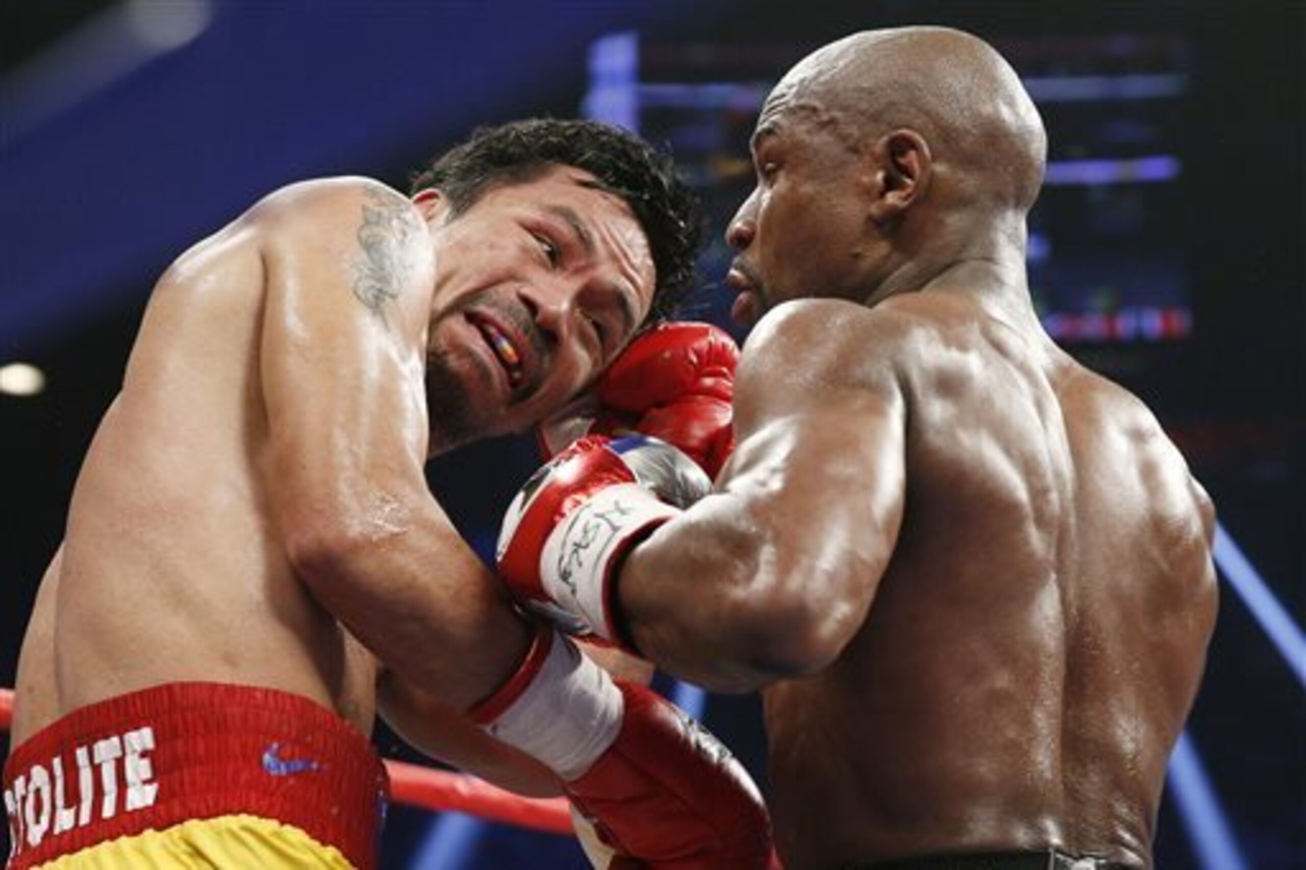 FILE - This May 2, 2015 file photo shows Manny Pacquiao, from the Philippines, left, trades punches with Floyd Mayweather Jr., during their welterweight title fight in Las Vegas. Boxing fans across the country or at least their lawyers are calling the hyped-up fight between Pacquiao and Mayweather a fraud. Some 31 class action lawsuits had been filed through Friday alleging primarily the same thing: that Pacquiao's pre-existing shoulder injury should have been disclosed to fans ahead of time.  (AP Photo/John Locher, File)