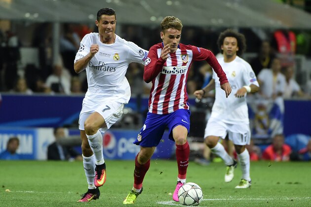 Real Madrid's Portuguese forward Cristiano Ronaldo (L) fights for the ball with Atletico Madrid's French forward Antoine Griezmann during the UEFA Champions League final football match between Real Madrid and Atletico Madrid at San Siro Stadium in Milan, on May 28, 2016. / AFP / OLIVIER MORIN        (Photo credit should read OLIVIER MORIN/AFP/Getty Images)