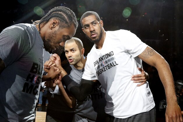 SAN ANTONIO,TX - FEBRUARY 3: Kawhi Leonard #2 of the San Antonio Spurs,Tony Parker #9 of the San Antonio Spurs and LaMarcus Aldridge #12 of the San Antonio Spurs huddle before their game against the New Orleans Pelicans at AT&T Center on February 3, 2016 in San Antonio, Texas.  NOTE TO USER: User expressly acknowledges and agrees that , by downloading and or using this photograph, User is consenting to the terms and conditions of the Getty Images License Agreement. (Photo by Ronald Cortes/Getty Images)